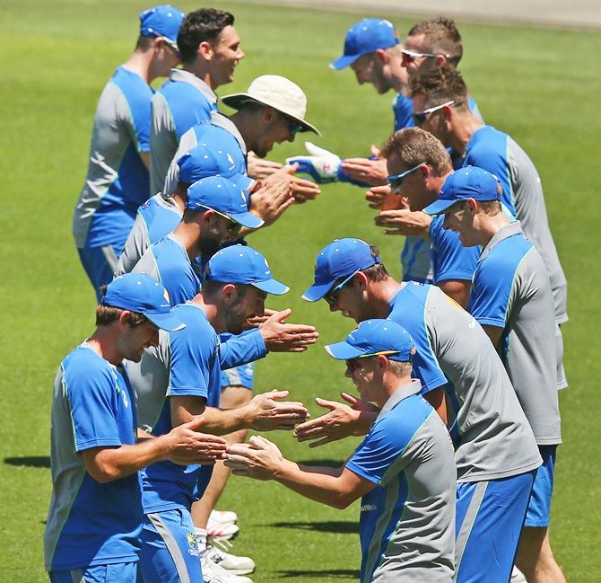 Australian players particpate in a game of hand slapping during a nets session