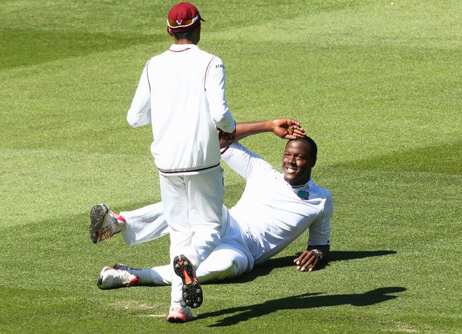 West Indies' Carlos Brathwaite celebrates after dismissing Australia's David Warner