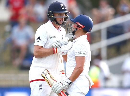 James Taylor of England congratulates Joe Root after he reached his 50 runs 