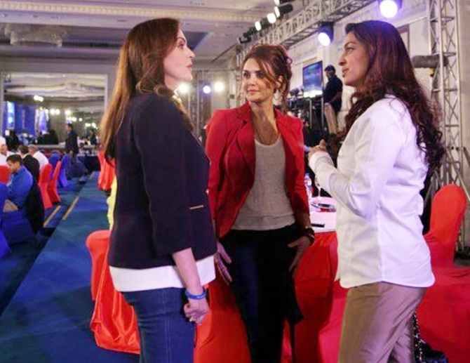 Preity Zinta of Kings XI Punjab, centre, Juhi Chawala of Kokata Knight Riders, right, and Nita Ambani of Mumbai Indians during the IPL 7 Player Auction 