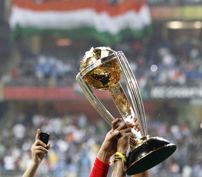 Players hold the trophy during celebrations