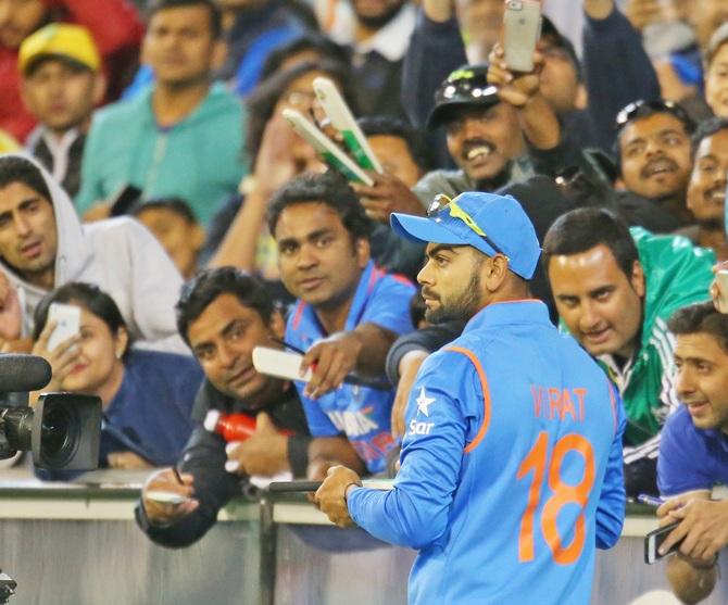 Virat Kohli of India signs autographs