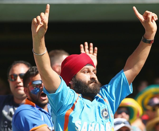 An Indian supporter in the crowd enjoys the atmosphere