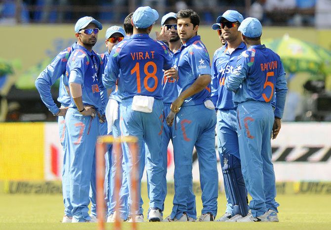 India's Mohit Sharma celebrates with teammates the fall of a wicket