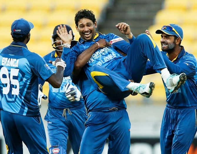 Tillakaratne Dilshan of Sri Lanka is congratulated by teammates