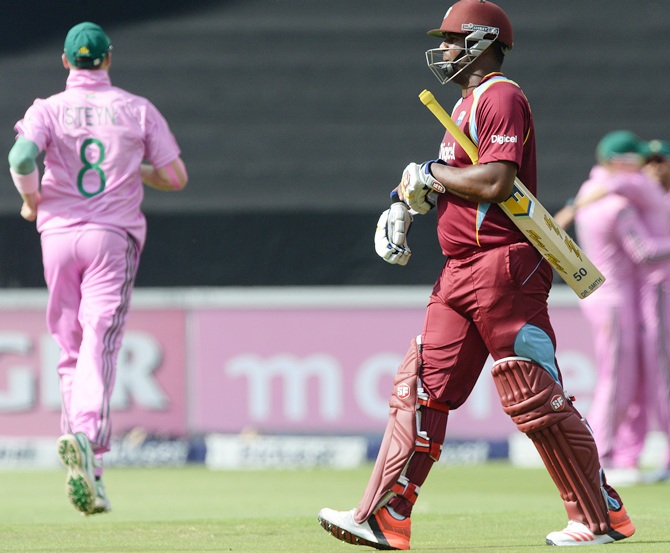 Dwayne Smith of West Indies walks off