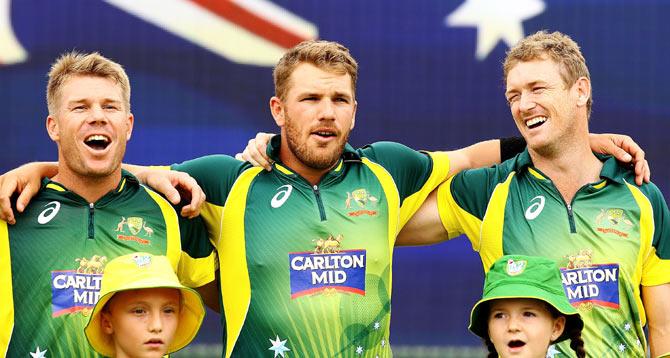 David Warner, Aaron Finch and George Bailey of Australia sing the Australian national anthem 