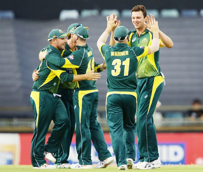 Josh Hazlewood of Australia celebrates with teammates after taking a wicket