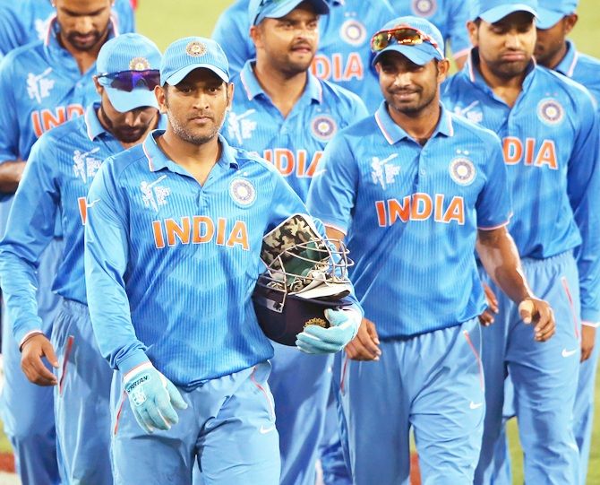 Mahendra Singh Dhoni of India leads the team off the field
