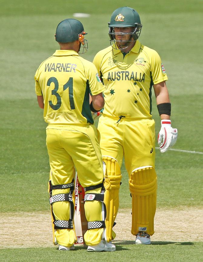 Australia openers David Warner and Aaron Finch speak between overs