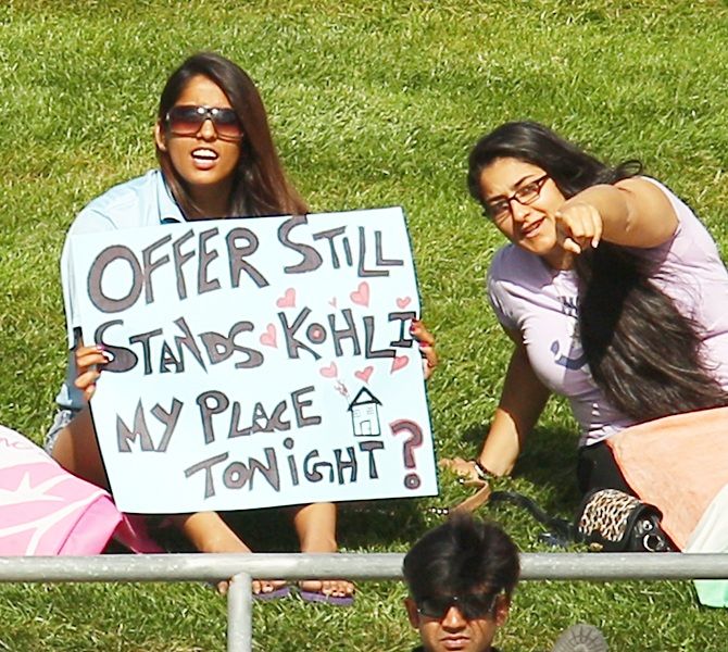  A young lady holds a sign aloft during ODI match