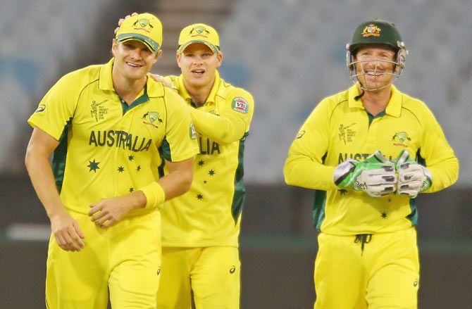 Australia's Shane Watson is congratulated by Steven Smith and Brad Haddin after taking a catch at slips to dismiss Mohammad Naveed of the United Arab Emirates during their Cricket World Cup warm-up match at Melbourne Cricket Ground on Wednesday