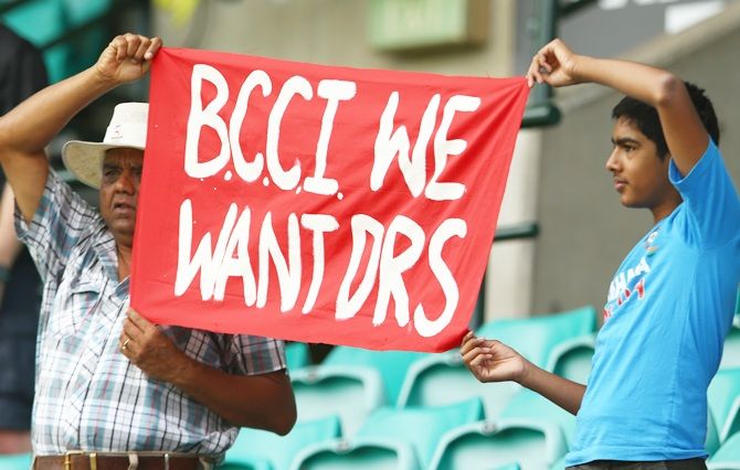 Indian supporters in the crowd hold up a sign about the DRS