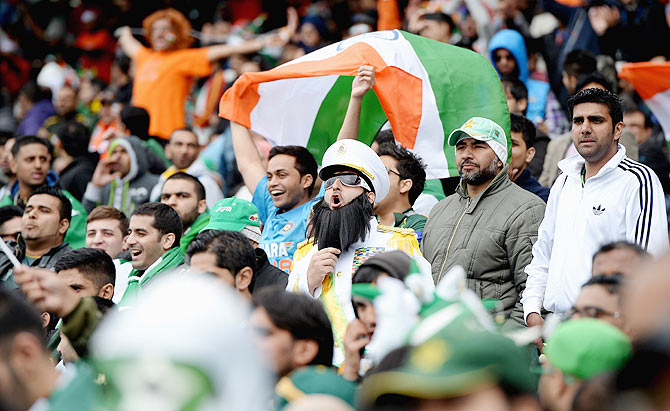 Pakistan and India fans cheer during the ICC Champions Trophy match between India and Pakiatan in June 2013