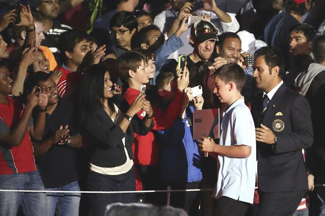 India's captain Mahendra Singh Dhoni (front right) makes his way through the crowd, to be presented on stage during the ICC Cricket World Cup 2015 opening event, at the Sidney Myer Music Bowl in Melbourne, on Thursday