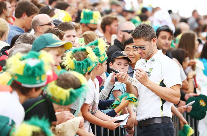 Michael Clarke sign autographs for fans