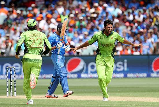 Pakistan player Sohail Khan celebrates the wicket of India's Rohit Sharma on Sunday