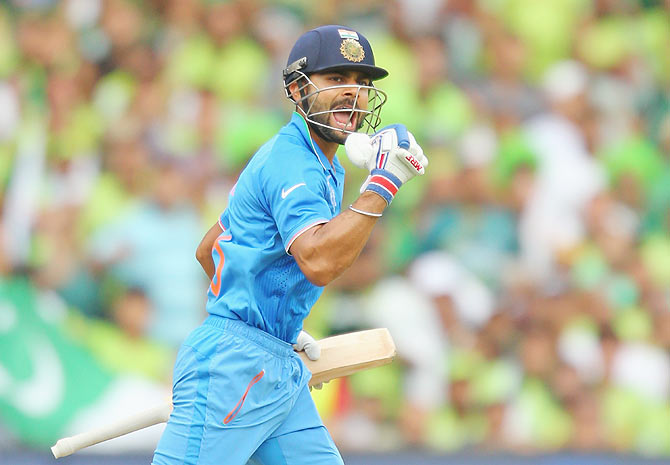 Virat Kohli of India celebrates as he reaches his century on Sunday