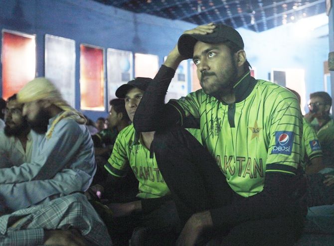 Pakistani fans watch their Cricket World Cup match against India, at an auditorium in Karachi