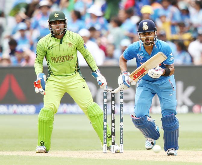 Virat Kohli of India bats as Pakistan 'keeper Umar Akmal looks on