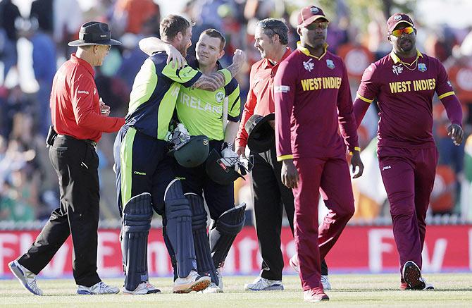 Ireland's John Mooney (2nd from left) hugs teammate Niall O'Brien (3rd from left) after beating the West Indies during their Cricket World Cup match in Nelson, New Zealand on Monday