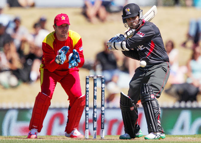 Shaiman Anwar of the United Arab Emirates bats as Zimbabwe 'keeper Brendan Taylor looks on