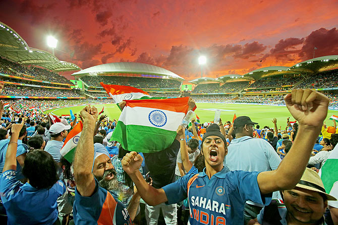 Indian fans in the crowd celebrate as a Pakistan wicket falls during the 2015 ICC Cricket World Cup match between India and Pakistan 