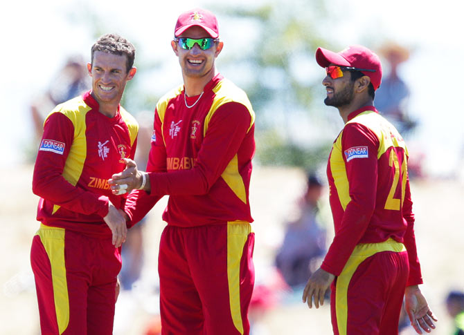 Sean Williams, Craig Ervine and Sikandar Raza of Zimbabwe celebrate the wicket of Shaiman Anwar of the United Arab Emirates on Thursday