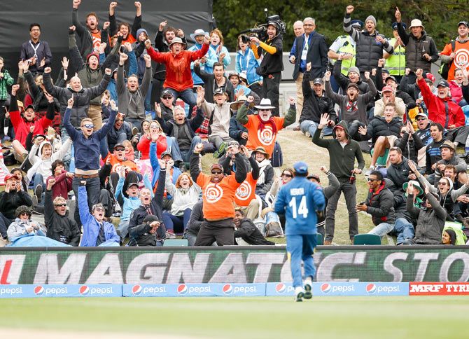 A spectator (centre) holds on to a one handed catch to win $1000,000 during the match between Sri Lanka and New Zealand at Hagley Oval in Christchurch on February 14