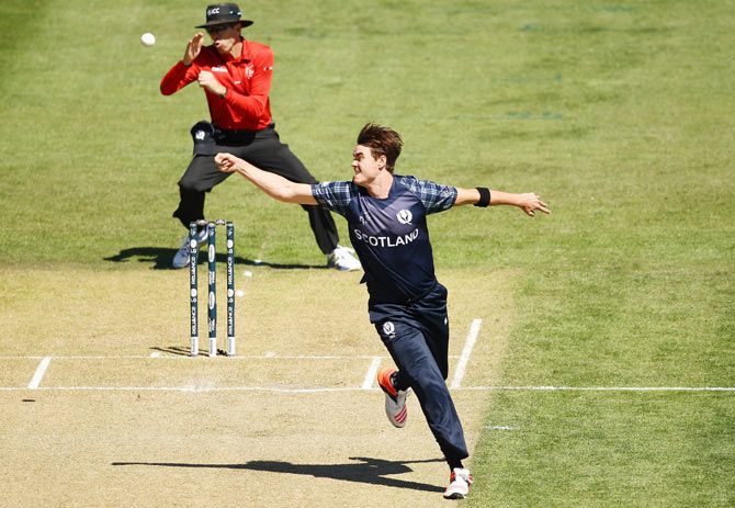 Iain Wardlaw of Scotland fields even as the umpire takes evasive action during the match between New Zealand and Scotland at University Oval in Dunedin on February 17