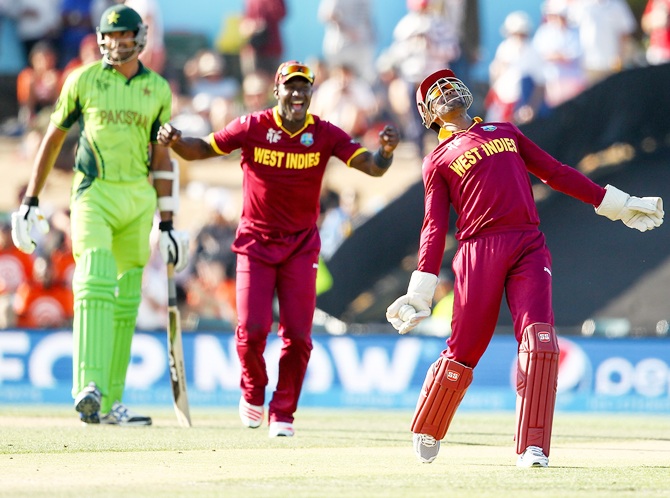 Denesh Ramdin, right, of West Indies celebrates holding a catch