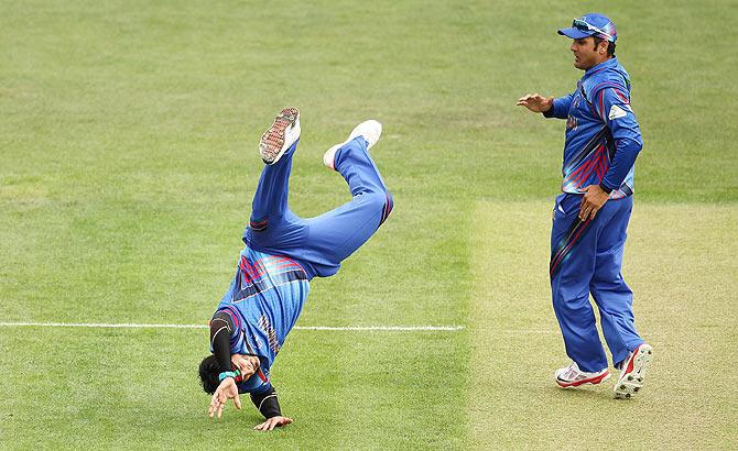 Hamid Hassan of Afghanistan does a cart wheel as he celebrates the wicket of Kumar Sangakkara of Sri Lanka