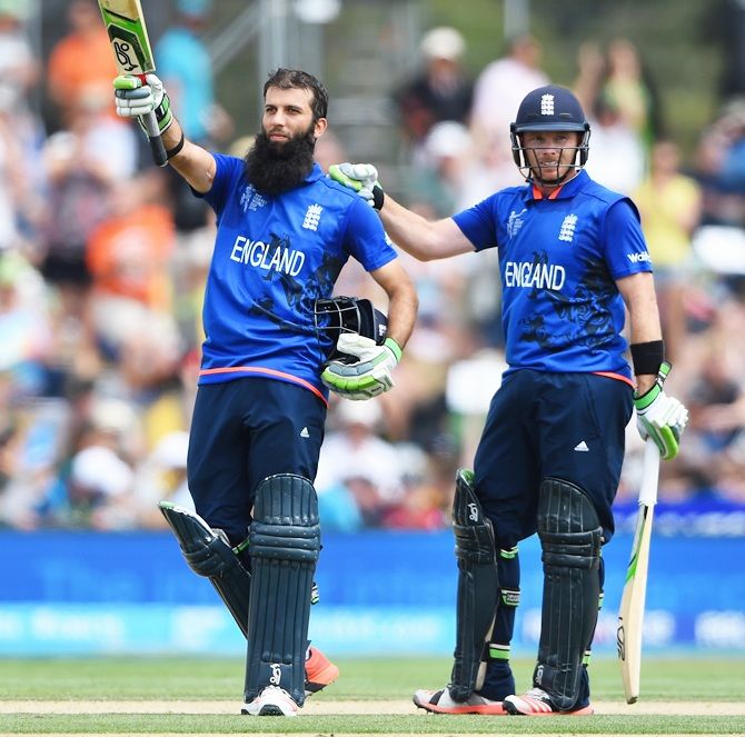 Moeen Ali of England is congratulated by team-mate Ian Bell after reaching his century