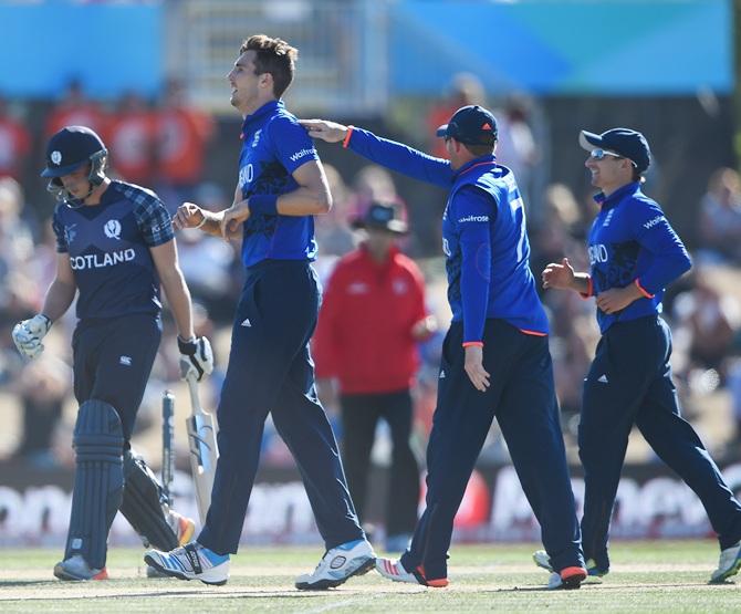 Steven Finn of England is congratulated by team-mate Ian bell after taking a wicket