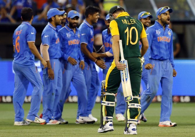The Indian team celebrates as South Africa's David Miller walks off