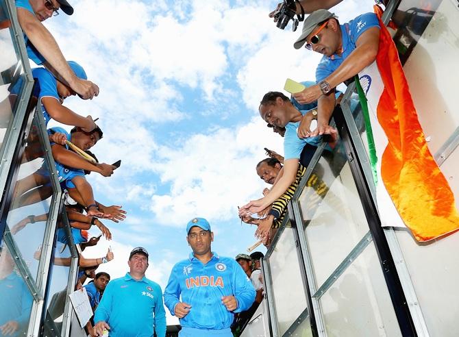 Mahendra Singh Dhoni of India walks down