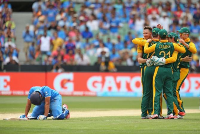 Rohit Sharma of India, left, looks dejected 