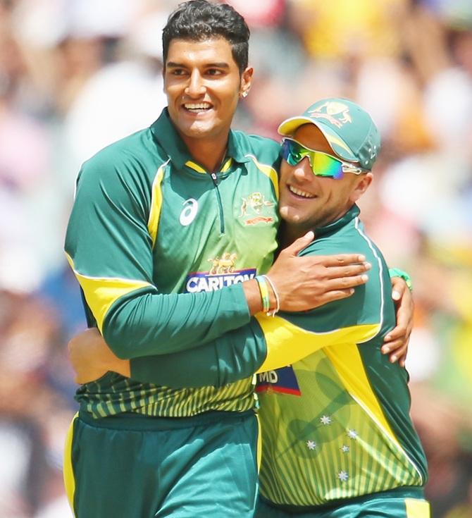 Gurinder Singh Sandhu of Australia celebrates with Aaron Finch