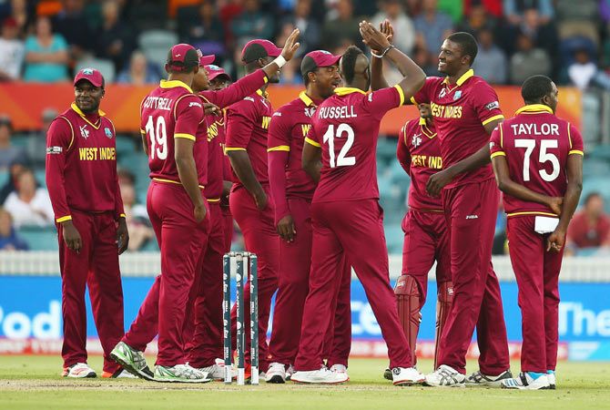 West Indies captain Jason Holder celebrates with teammates after taking a wicket 