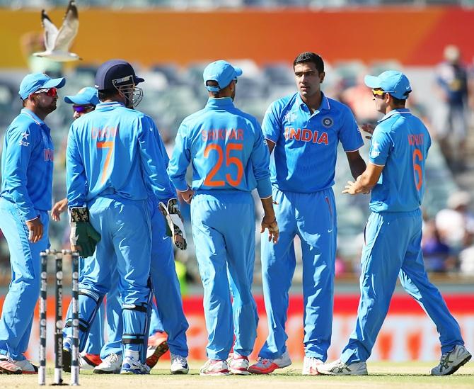 India skipper Mahendra Singh Dhoni celebrates with Ravichandran Ashwin