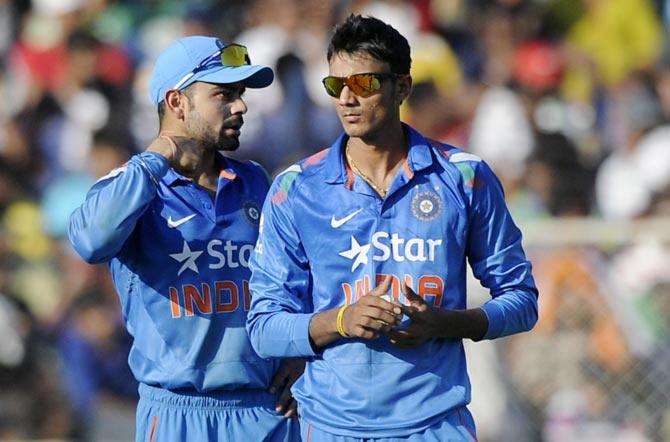 Axar Patel (right) with Virat Kohli