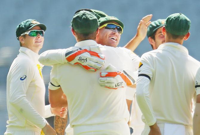 Brad Haddin of Australia is congratulated by teammates