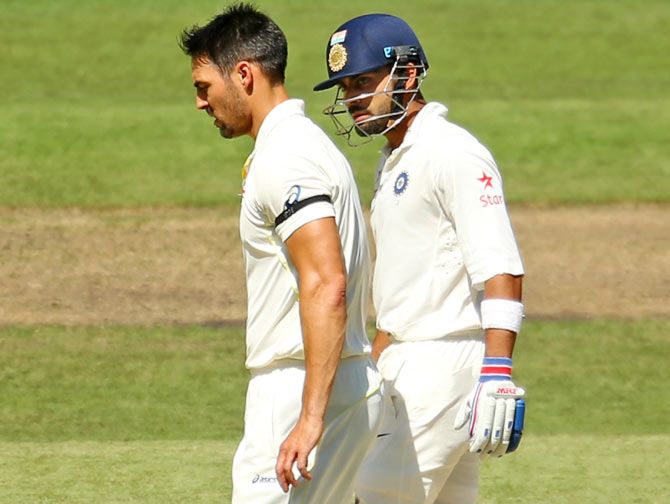 Virat Kohli, right, exchanges words with fast bowler Mitchell Johnson