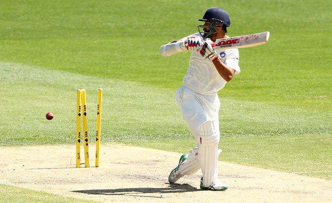 Shikhar Dhawan is bowled by Ryan Harris during the first Test in Adelaide