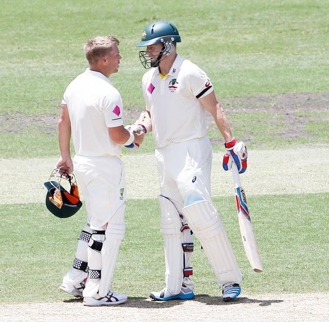 David Warner of Australia congratulates teammate Chris Rogers