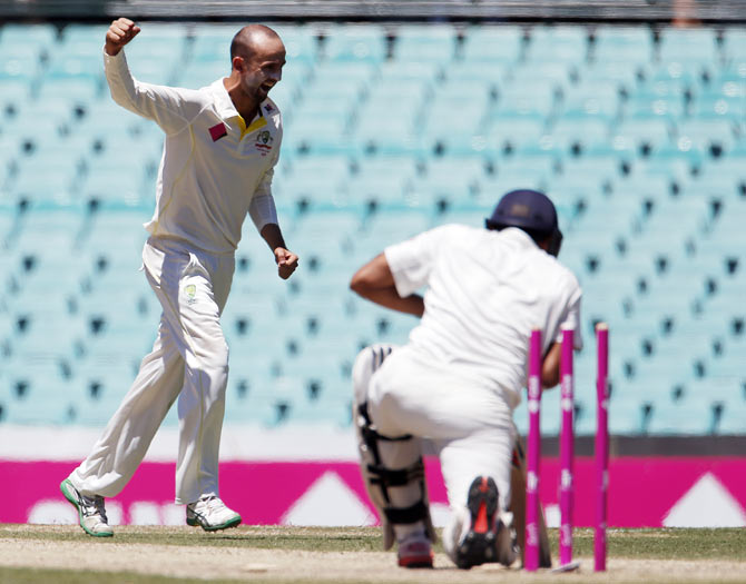 Australia's Nathan Lyon (left) celebrates after having Rohit Sharma bowled out for 53
