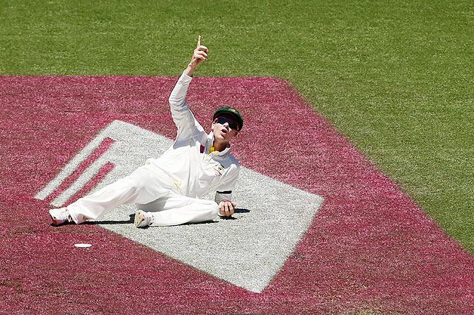 Australian captain Steve Smith looks skyward towards Spidercam after dropping a catch off Lokesh Rahul