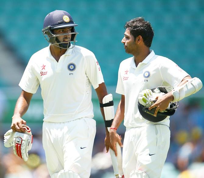 Ravichandran Ashwin of India talks to team mate Bhuvneshwar Kumar 