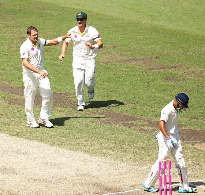 Ryan Harris of Australia celebrates taking the wicket of Virat Kohli of India