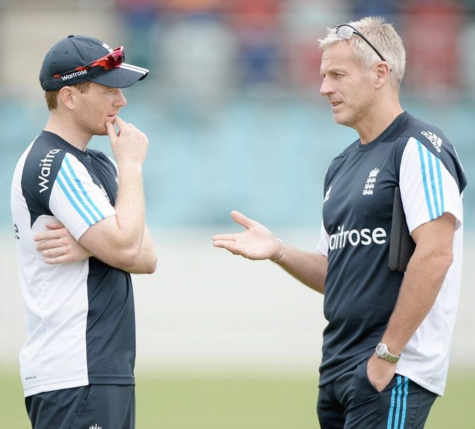 England captain Eoin Morgan speaks with England coach Peter Moores during a nets session